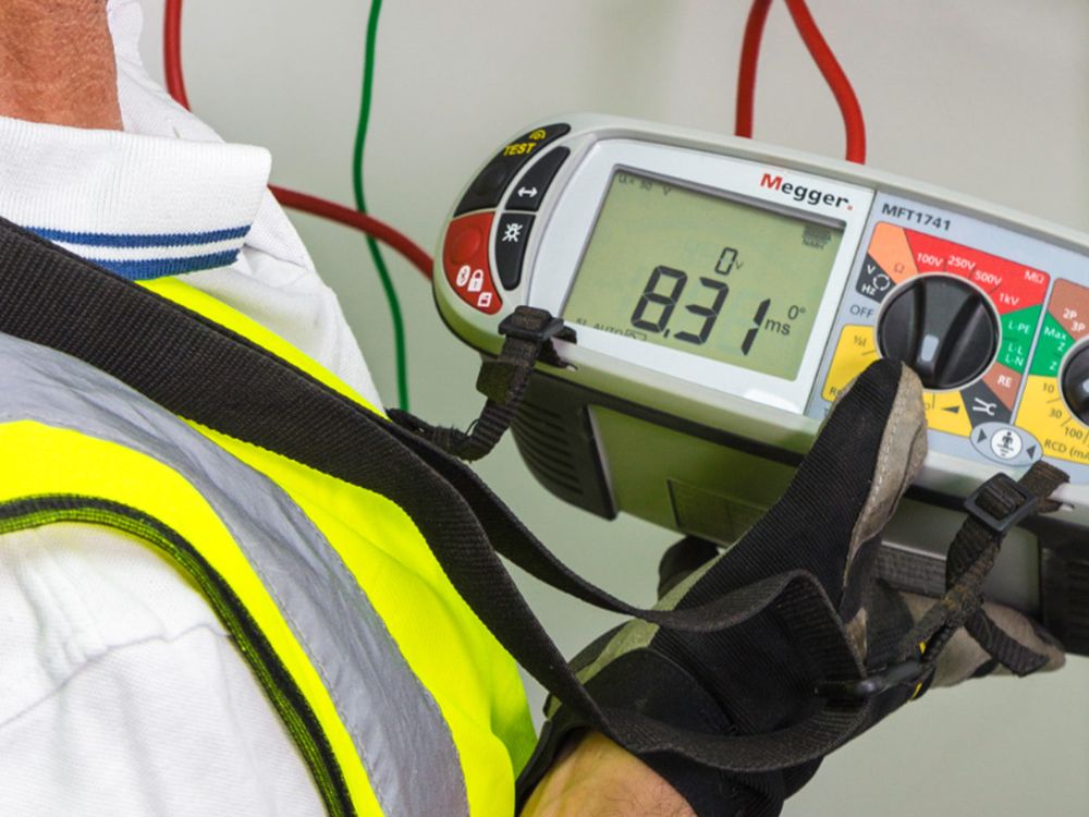 Electrician using a multifunction tester