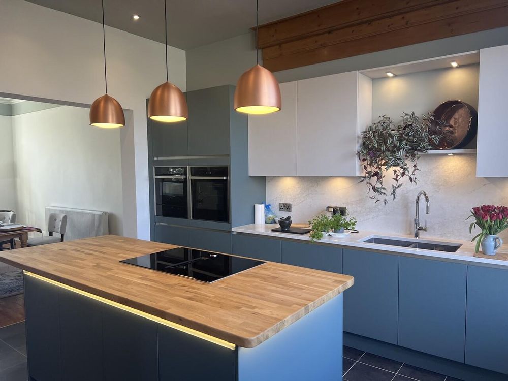 Kitchen with copper pendant lights over an island
