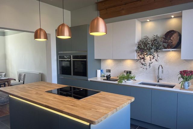 Kitchen with copper pendants and under-cabinet lighting